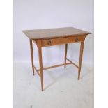 An Arts and Crafts oak single drawer side table, raised on tapering supports united by an H