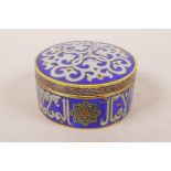 An Islamic cloisonne cylinder box and cover with script decoration, 3" diameter, 1½" high
