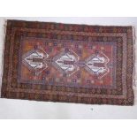 An Afghan hand woven wool rug with stylised bird and flower designs on a brown field, 60" x 36"