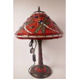 A Tiffany style table lamp with dragonfly decoration on a red ground, 21" high