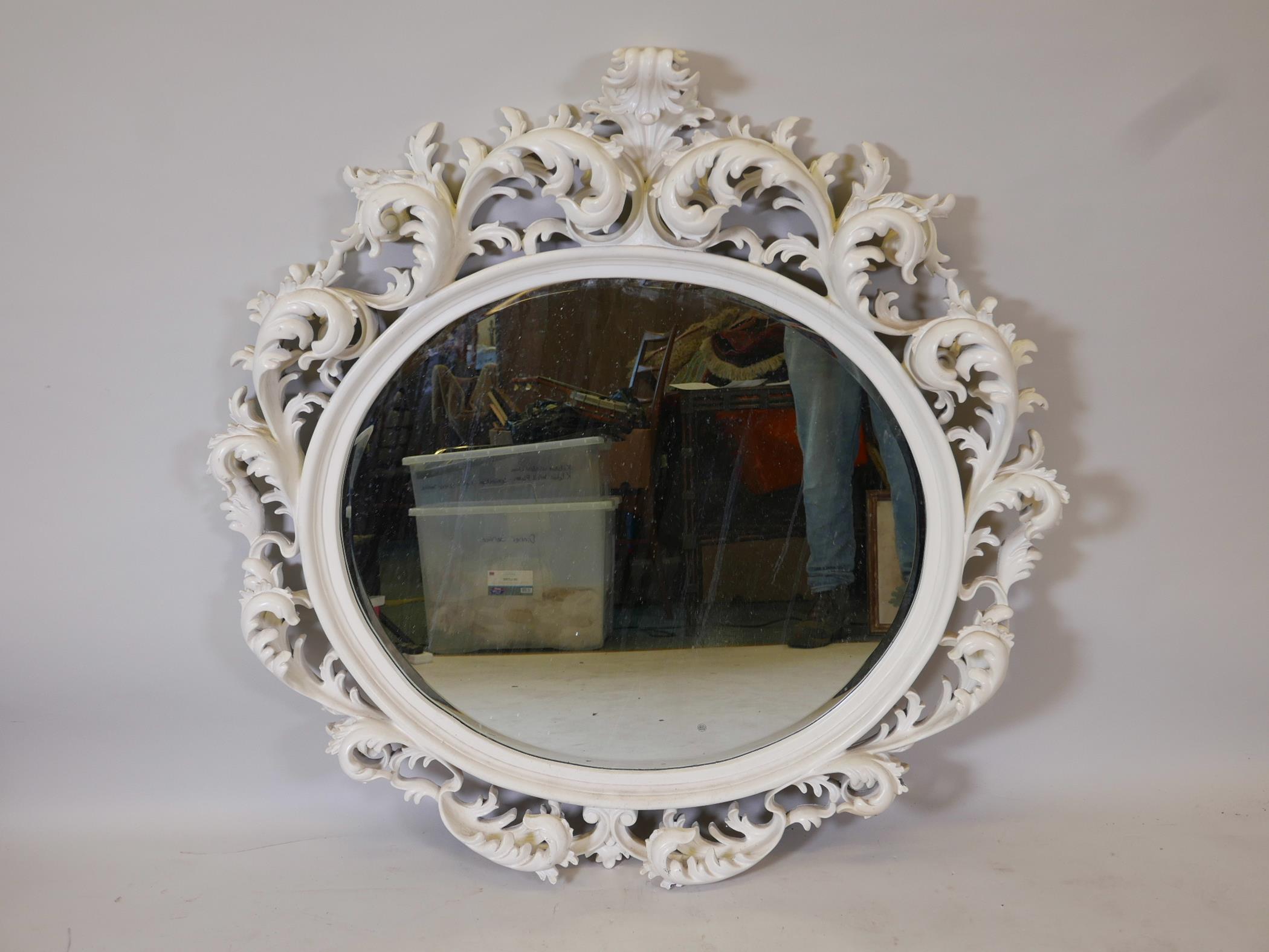 A carved and painted wood framed wall mirror with bevelled glass plate, 44" x 44"