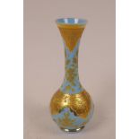 A Moser turquoise milk glass specimen vase with intricate gold overlaid floral decoration, 5" high