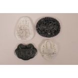 Four Chinese carved hardstone pendants decorated with auspicious characters, dragons and deities,