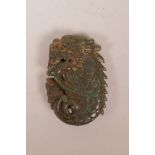 A Chinese spinach hardstone pendant carved in the form of a dragon, 2½"