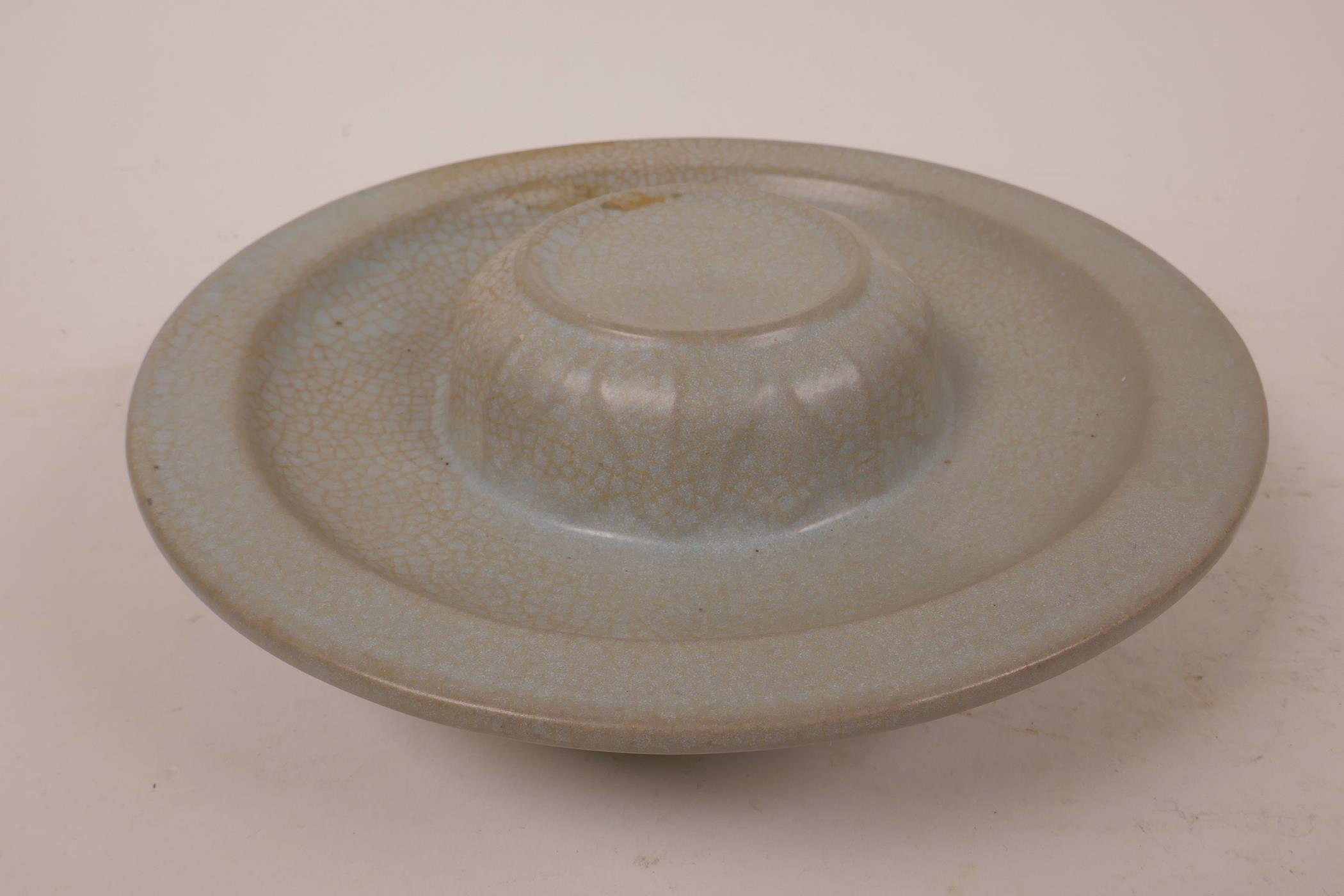 A ceramic stand with a celadon glaze, 7½" diameter