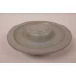 A ceramic stand with a celadon glaze, 7½" diameter