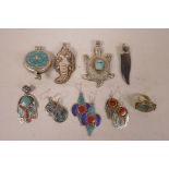 A quantity of Tibetan white metal and stone set pendants and earrings, largest 3"