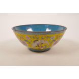 A Canton enamelled copper bowl, decorated with peaches, lotus flowers and phoenix, four character