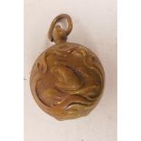 An Art Nouveau brass sovereign case with embossed decoration of swans, 1½" diameter