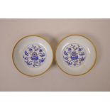 A pair of Chinese blue and white porcelain saucers decorated with the emblems of the eight