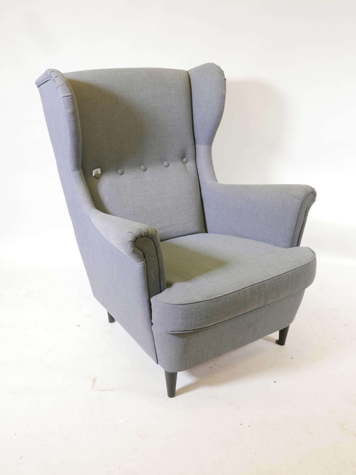 An Ikea 'Strandmon' wing back armchair, covered in 'Nordvalla dark grey', 41" high