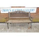 A wrought iron and teak slatted garden bench with a pierced iron back, 50½" wide, 34" high