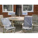 A Bramblecrest teak garden table and six chairs, and a large black parasol, table 77" x 59"