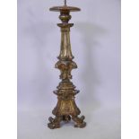 An early C19th Continental carved and gilded pine pricket candlestick, drilled at top for