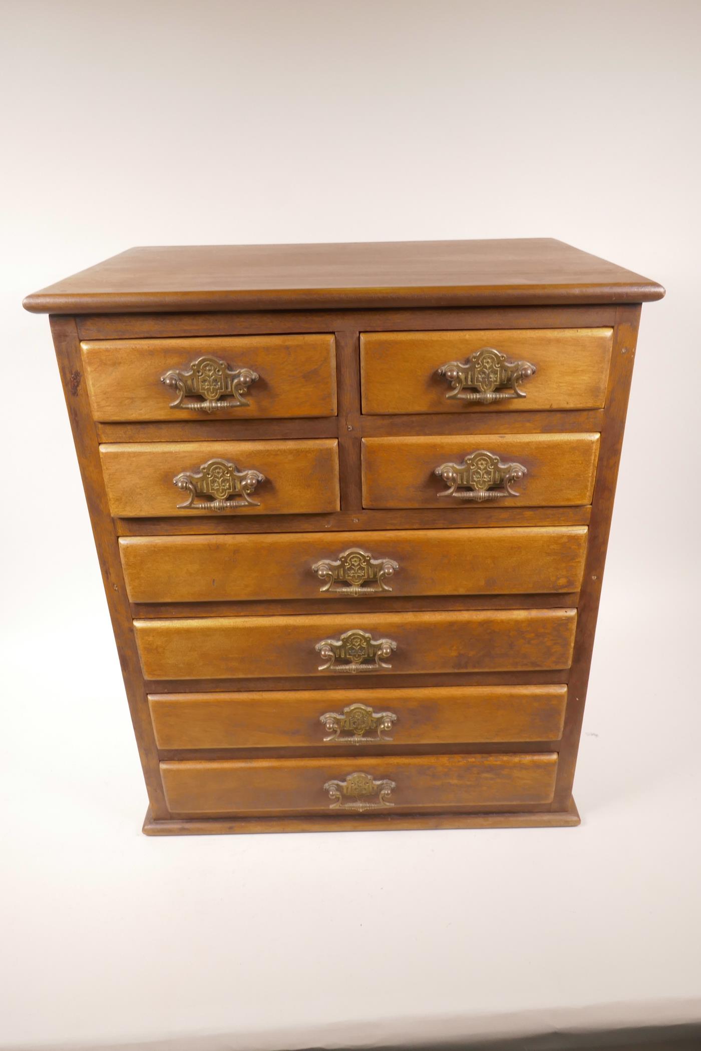 A small hardwood chest of four short over 4 long drawers with brass drop handles, 19" x 16" x 11"