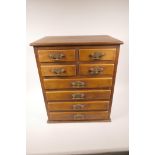 A small hardwood chest of four short over 4 long drawers with brass drop handles, 19" x 16" x 11"