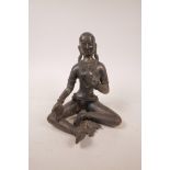 An Indian bronzed metal figure of a semi clad woman, seated in meditation, 8½" high