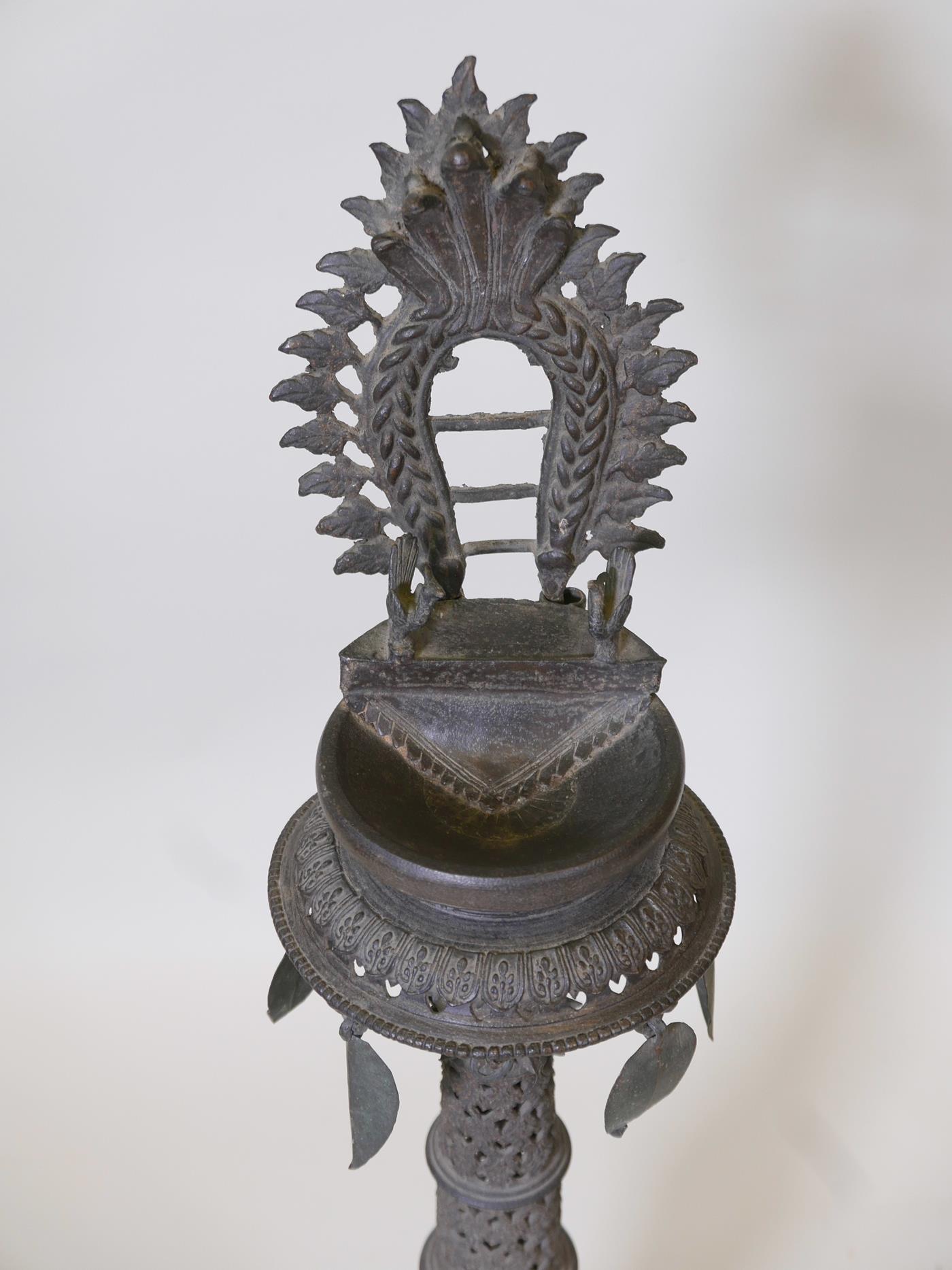 An Indian bronze standing lamp or stoop with pierced decoration to the column, 35" high x 10" - Image 4 of 4