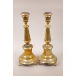 A pair of late C19th Continental gilt white metal candlesticks with primitve punched decoration of