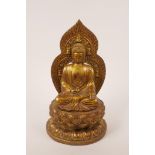 A Chinese gilt metal figure of Buddha seated on a lotus throne, impressed four character mark to