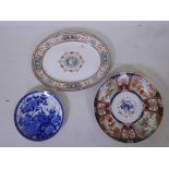 A C19th Imari charger, A/F, a blue and white plate with peacock decoration and a Minton's oval