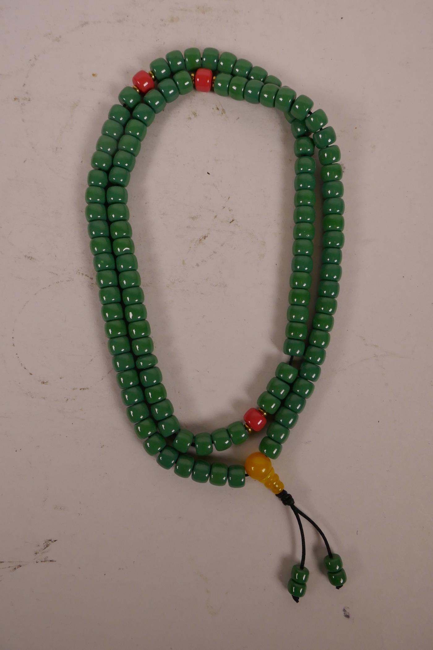 A string of green glass mala beads with coloured feature beads, 34" long