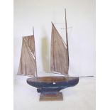 A late C19th/early C20th gaff rigged pond yacht, retaining original blue paint under varnish, hull