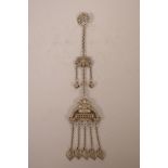 A Chinese white metal chatelaine pendant decorated with bats, auspicious symbols and flowers,
