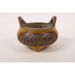 A Chinese bronze two handled censer with cloisonne decoration and panels with cursive