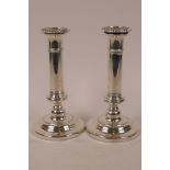 A pair of Regency style Sheffield plated candlesticks, with plain columns and turned bases, 8" high