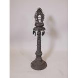 An Indian bronze standing lamp or stoop with pierced decoration to the column, 35" high x 10"
