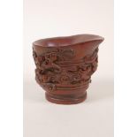 A Chinese carved bamboo libation cup decorated with climbing kylin, 3" high