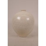 A Chinese cream ground pottery vase with incised decoration depicting a phoenix and lotus flowers,