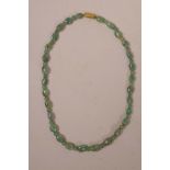A green jade bead necklace with a gilt metal clasp, 17" long
