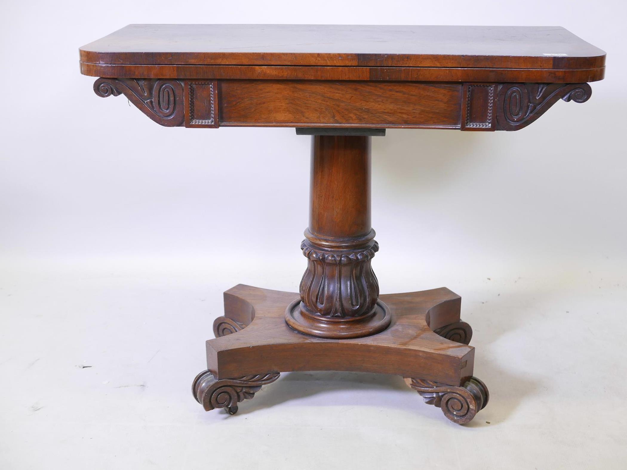 A William IV overgrained rosewood fold over card table, with inset baize top, raised on carved