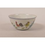 A Chinese doucai porcelain tea bowl with chicken decoration, six character mark to base, 3" diameter