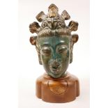 A Chinese ceramic head of a deity with coronet on a later wooden base, 10" high x 6" wide