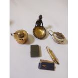 A collection of vintage curios, four cigarette lighters, a brass spirit burner and a bronze and