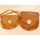 A leather shoulder bag together with a similar handbag with twist handle, both with brass Mulberry