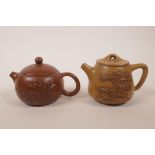 A Chinese Yixing teapot with raised floral decoration, together with another beige Yixing teapot