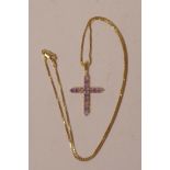 An 18ct gold and amethyst cross on a delicate 18ct gold chain, 16" long, gross 5.7g