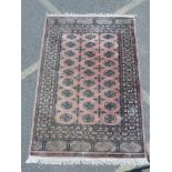 An Afghan terracotta ground rug with a Bokarra pattern, 49½" x 75"