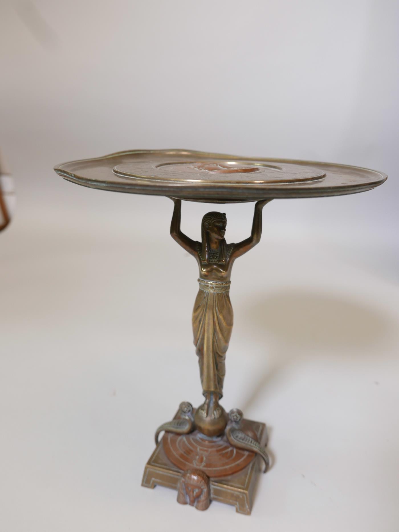 A French Art Deco brass and copper tazza, the top with engraved zodiac figures and a central