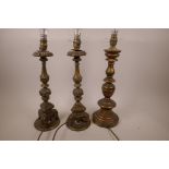 A pair of carved wood and plaster table lamps in the form of candlesticks, 17" high, and a similar