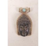 A Tibetan white metal and composition pendant with Quan Yin head decoration, 3"