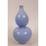 A Chinese powder blue glazed double gourd vase, cracks to glaze, 9" high