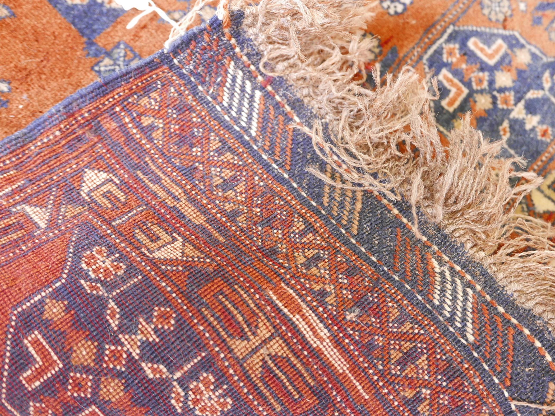 An Afghani wool rug with geometric patterns on a rust coloured field, 51" x 33" - Image 3 of 3