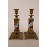 A pair of candlesticks with cast brass bases and enamel decorated columns,possibly Indian, 9" high x