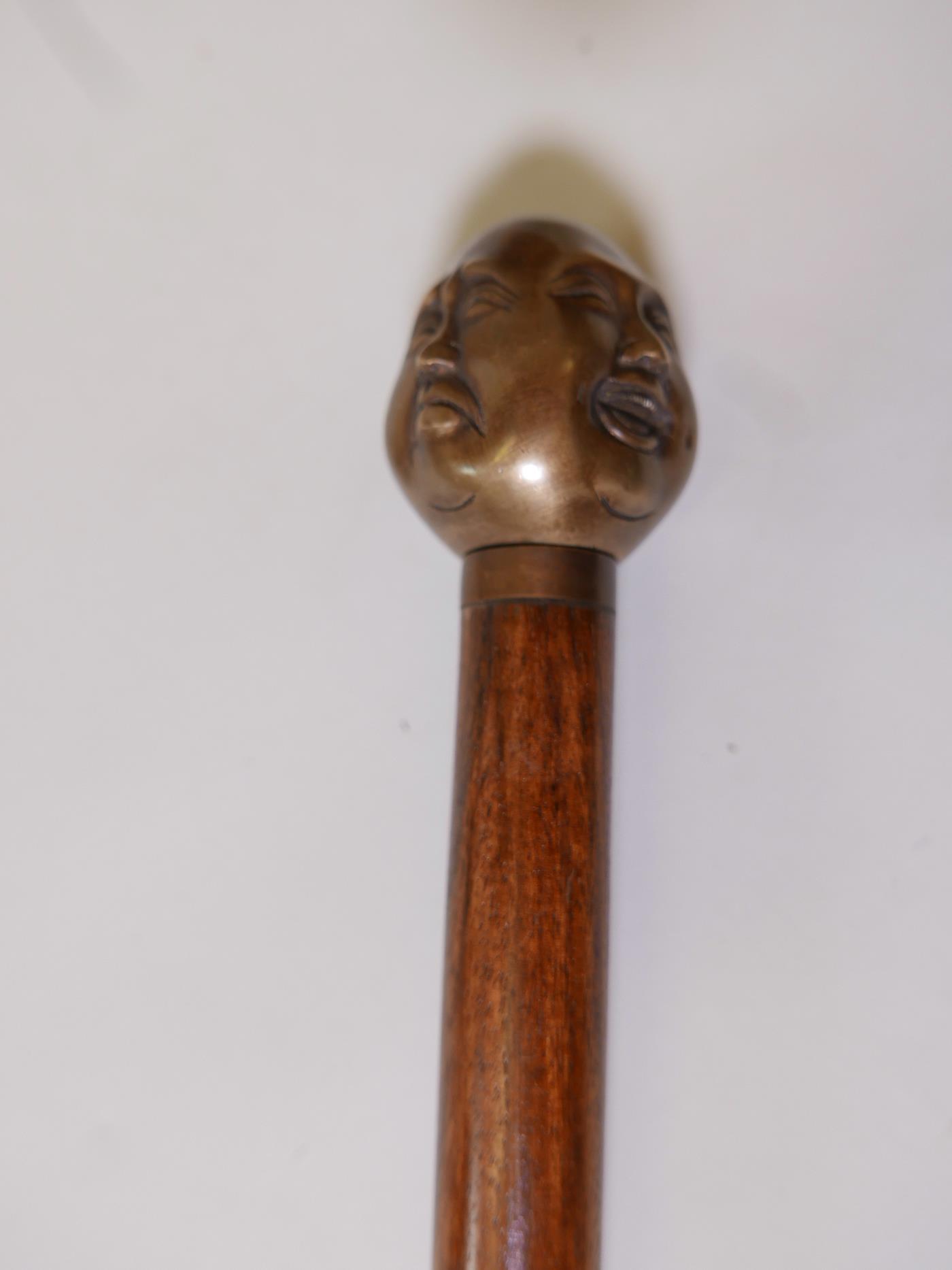 A hardwood walking stick with brass four-face Buddha head handle, 36" long - Image 2 of 4
