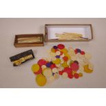 A quantity of Chinese dyed bone gaming chips together with a box of bone and wood gaming sticks, a